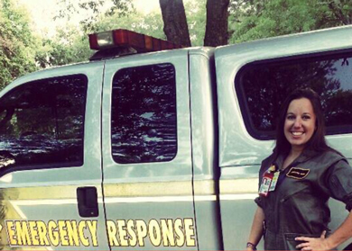 Jennifer Paris poses for a picture in front of an emergency response vehicle in 2012. Credits: Jennifer Paris