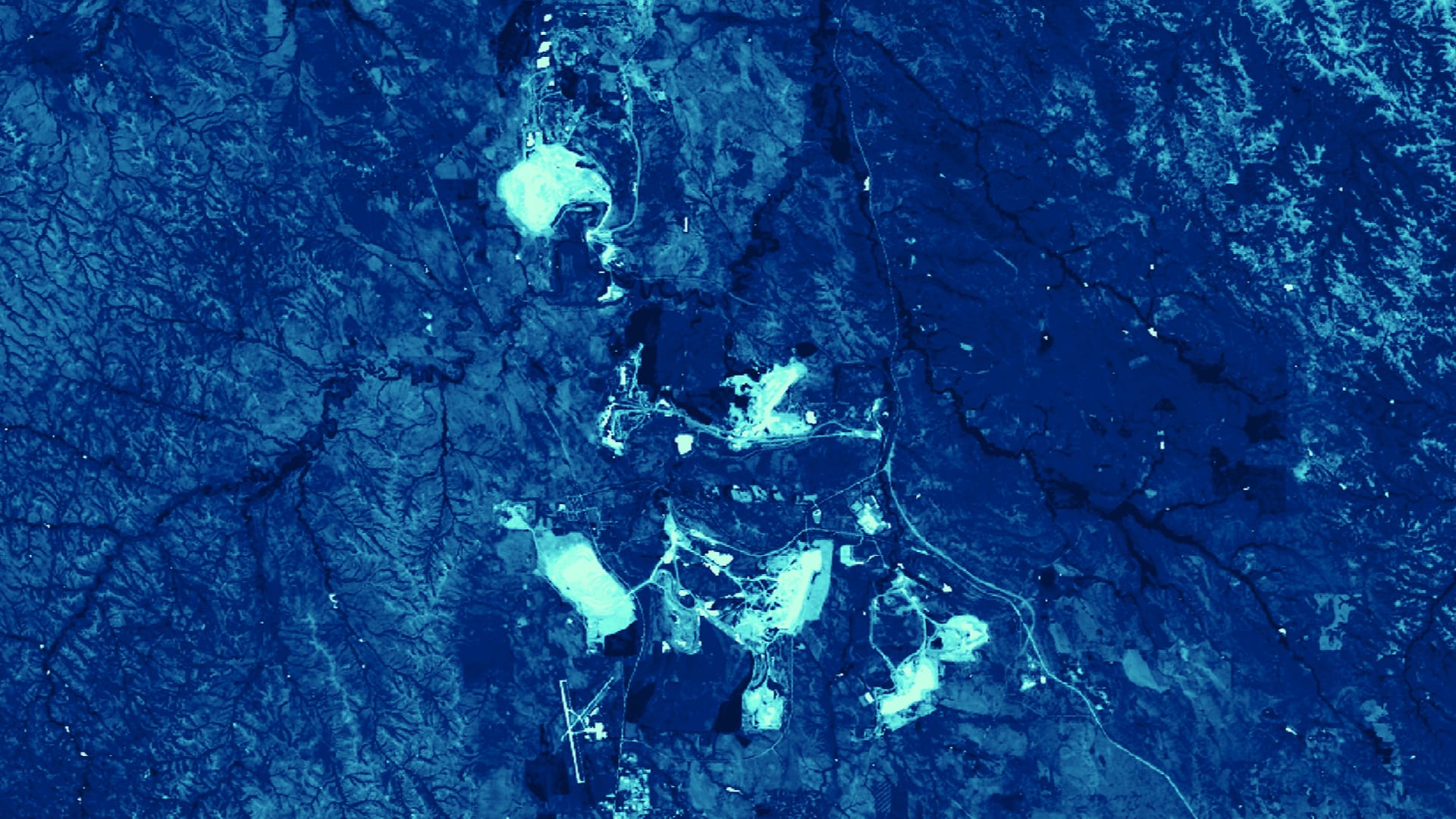 Tasseled cap angle transformation applied to 2018 Landsat 8 OLI imagery. Coal mines in the Powder River Basin of Wyoming are displayed. Lighter shades of blue indicate a higher ratio of barren land to vegetation and darker shades indicate a lower ratio of barren land to vegetation. End users can use this transformation as a proxy for identifying how barren, mined lands change over time.