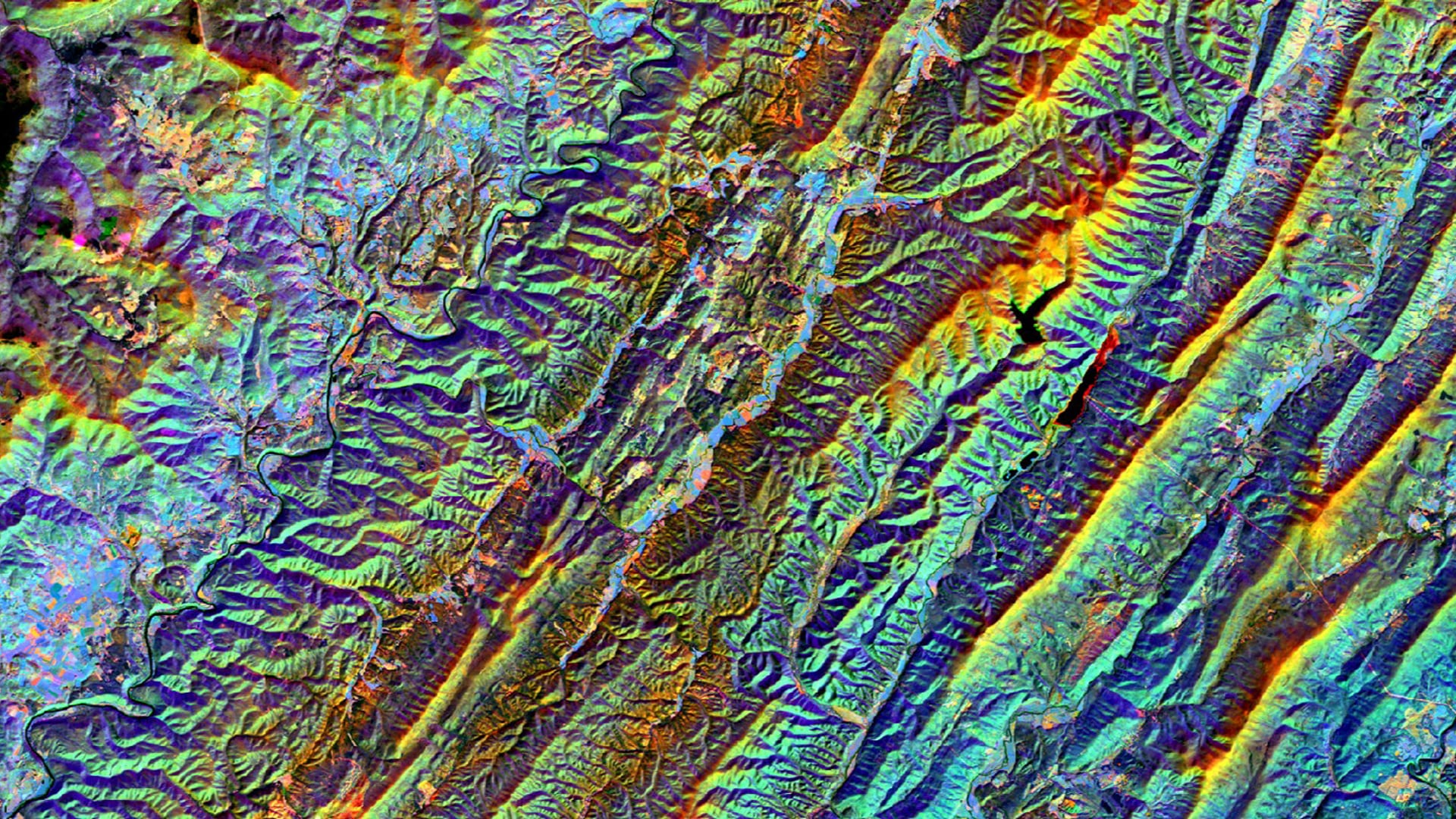 Split-season composite from May (leaf-on) and November (leaf-off) 2018 in the Allegheny Mountains of West Virginia. This Landsat 8 OLI imagery displays a color combination of SWIR_1 (leaf-on), SWIR_1 (leaf-off), and NIR (leaf-on). Urban areas are shown in pink, impervious surfaces in periwinkle, conifer forests in dark green, and exposed soil in orange. This stack, and others like it, are used for determining land cover classifications and collecting training data for forest restoration efforts.