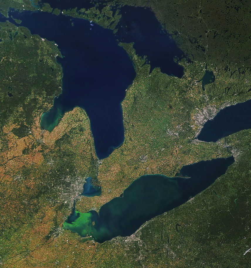 An algal bloom in western Lake Erie, visible as swirls of green.
