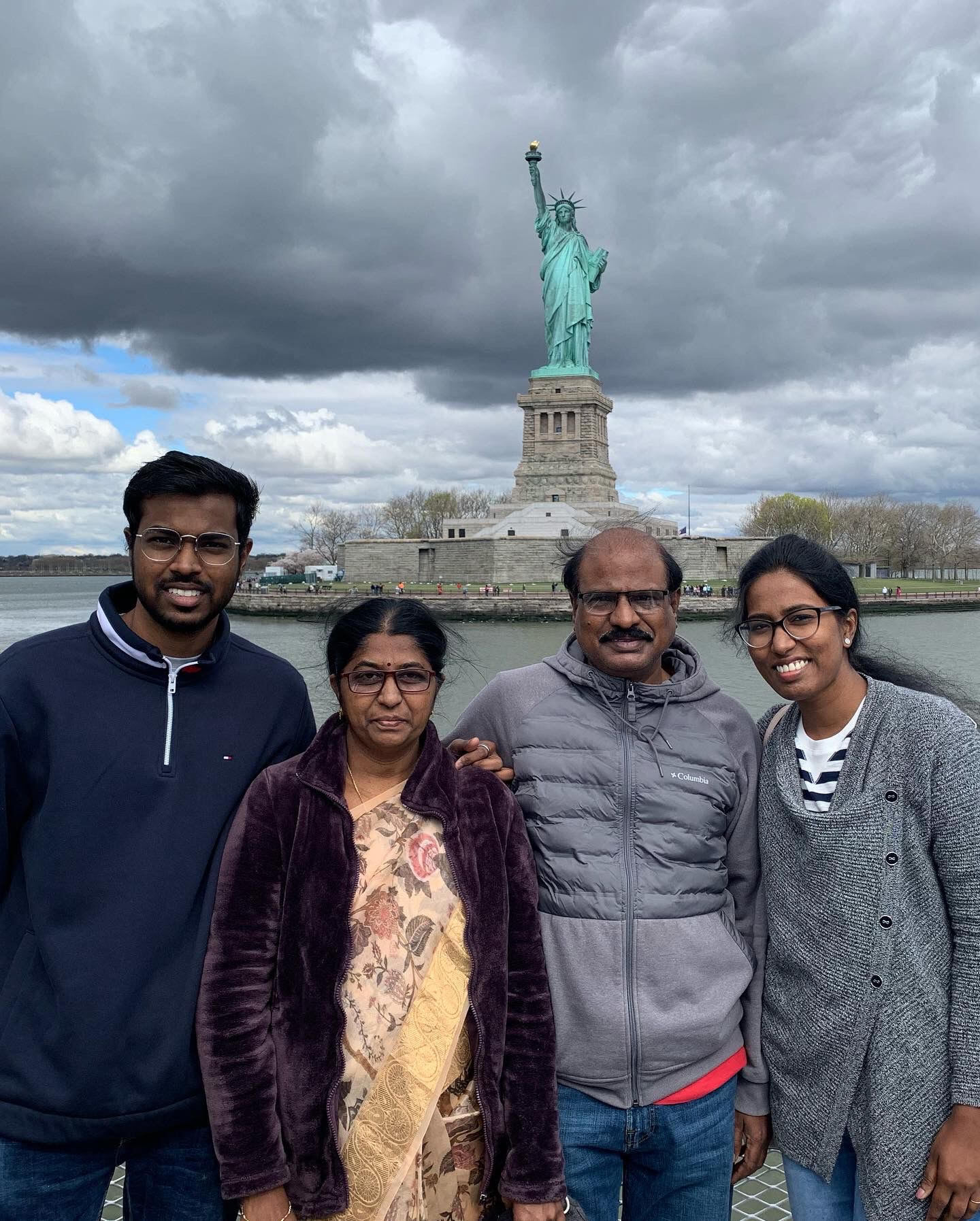 Family in front of Statue of Liberty