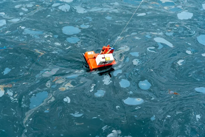 An oil sampler deployed from the U.S. Coast Guard Cutter Blackfin measuring oil thickness of a natural oil seep on the ocean surface near Santa Barbara, California, during a marine oil spill thickness field test on May 10, 2021. Credits: NASA/University of Maryland/Frank Monaldo