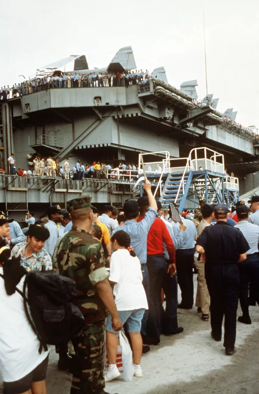 U.S. military dependents board the nuclear-powered aircraft carrier USS Abraham Lincoln (CVN-72) on June 17, 1991, as they prepare to depart in the aftermath of Mount Pinatubo's eruption. Credits: U.S. Navy/Patrick Muscott