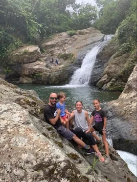 photo of family in front of waterfall