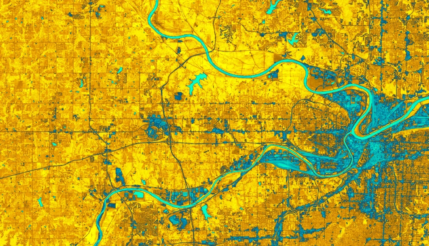 2010 – 2021 NDWI-processed imagery of the greater Kansas City, Kansas region. This image combines Landsat 5, 7, and 8 highlighting dry areas in yellow through orange. Areas classified as water are identifiable in aqua blue. Areas of darker blue are considered wet but include cityscape. A major problem for urban flooding identification is the mixture of cityscape in wet areas, making it important for further investigation and data processing.