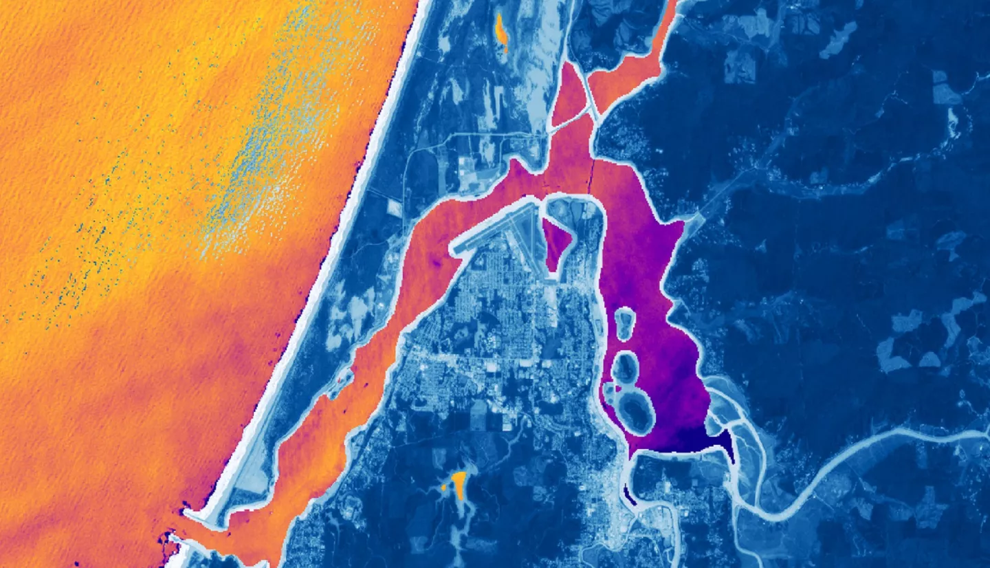 ACOLITE and NDVI processed imagery from Landsat 9 OLI-2 data. This composite image of the Coos Estuary and surrounding area was taken in September of 2022 after a period of increased precipitation. Shades of blue indicate vegetated land surface. The darker purple indicates higher turbidity while the lighter orange indicates lower turbidity. 