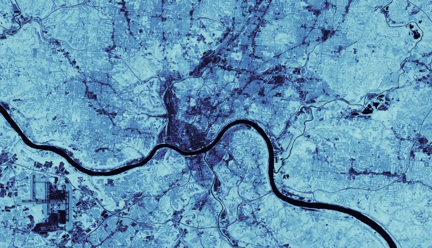 NDVI-processed imagery from 2020 Landsat 8 OLI data of the greater Cincinnati, OH and Covington, KY area. Lighter blues show denser vegetation while darker blues depict highly urbanized areas. The darkest blue line represents the extent of the Ohio River. Urban areas lacking slope-stabilizing and run-off retaining vegetation are more susceptible to landslides and flooding.  Keywords: NDVI, landslide susceptibility, InVEST, urban flood mitigation