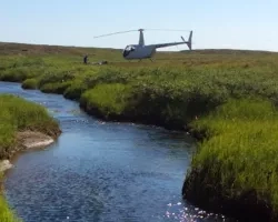 photo of helicopter over stream