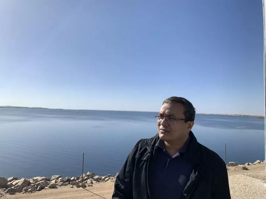 photo of man looking out over a large body of water