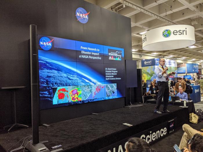 NASA Disasters Program Manager David Green giving a talk on the NASA Hyperwall at AGU 2019. Credit: Jacob Reed (NASA GSFC)