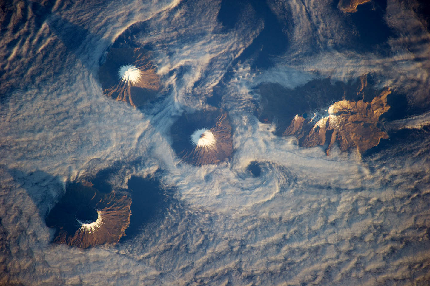 Clouds swirl around the Islands of the Four Mountains in Alaska’s Aleutian chain.