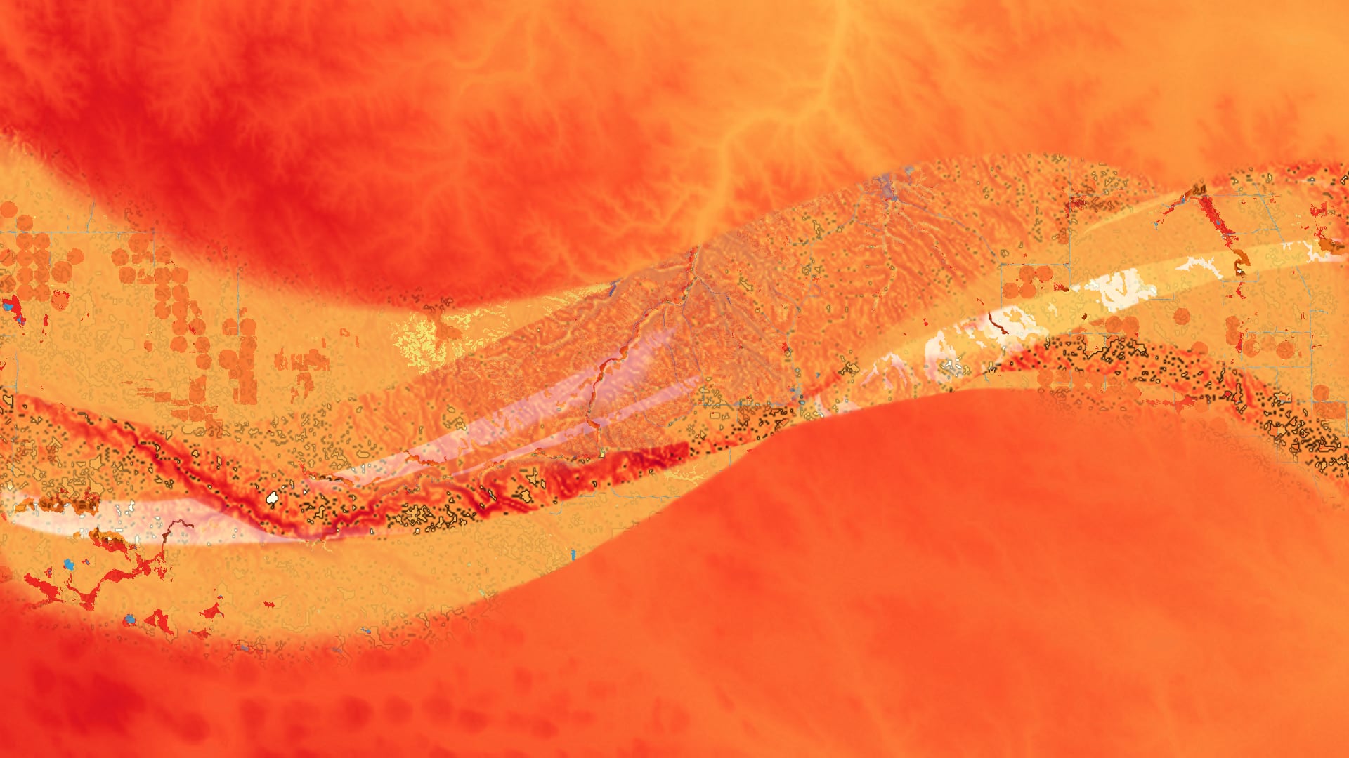 Blended image of a DEM from NASA’s SRTM, slope processed from the DEM, NLCD 2016 data, and a 2018 Soil Survey Geographic Database from the Natural Resources Conservation Service over the state of South Dakota, showing a section of the Rosebud Sioux Reservation Land. The dominant layer of DEM shows higher elevation in dark red and lower elevation in lighter red to yellow; all these layers help highlight the risk of flooding in this landscape.  Keywords: SRTM, DEM, NLCD, Soil Survey, South Dakota, Indigenous Peoples, Flood Mapping, Flood Risk