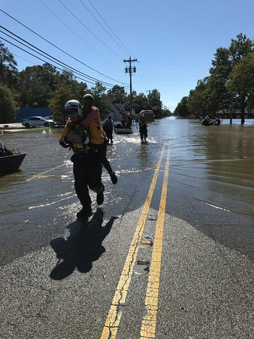 A first responder from New Jersey assisting during the hurricane in Lumberton, N.C., rescuing a woman from the flood waters.