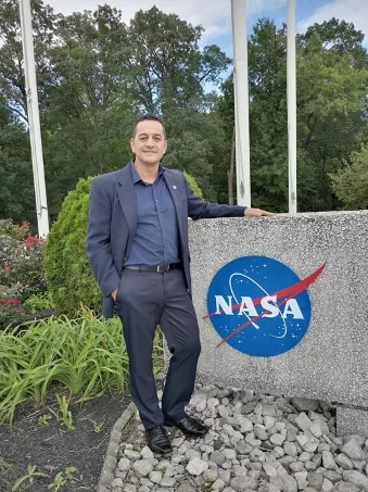 Photo of man (Ricardo Quiroga) with NASA logo
