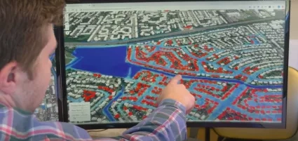 Researcher Derek Loftis showing computer model of houses affected by frequent flooding.