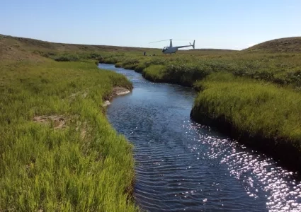 photo of helicopter over stream