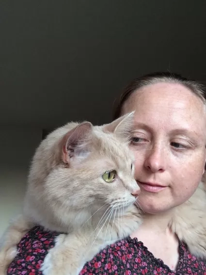 cat on woman shoulder