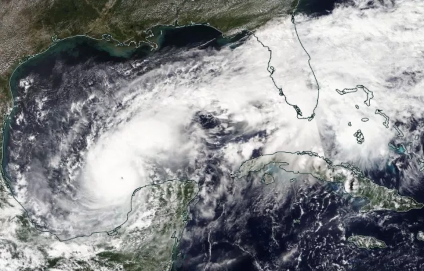 A satellite map of Hurricane Milton in the Gulf of Mexico, a large swirling mass of white clouds. 