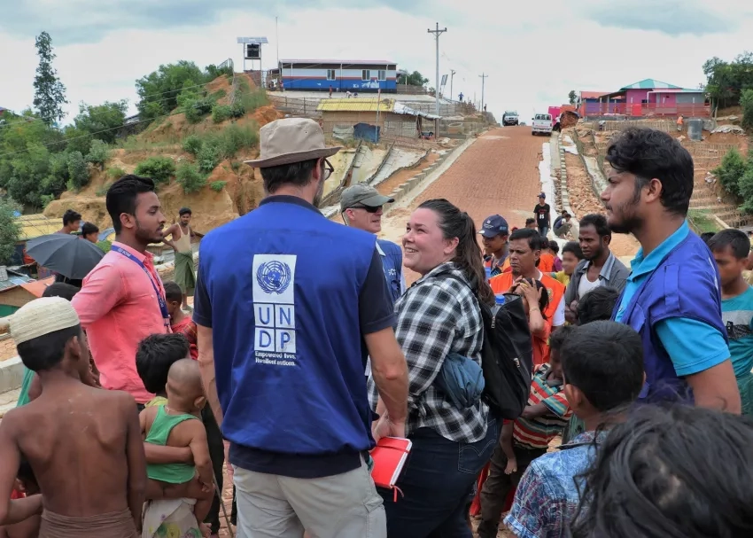 Shanna McClain speaks with a member of the United Nations Development Programme at a Rohingyan refugee camp. NASA provided the displaced community with data to reduce landslide risk in the refugee camps. NOTE: Some details in this photograph have been digitally obscured. Credits: NASA/Shanna McClain
