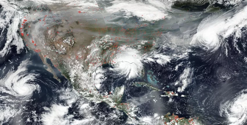 An image of the United States and Central America from September 2020, showing fires and their smoke in the west, several hurricanes converging, and Hurricane Sally making landfall. The true-color image was taken by NOAA/NASA’s Suomi NPP satellite.