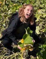 woman in field laughing