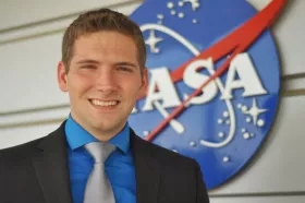 Josh Kelly in front of NASA logo