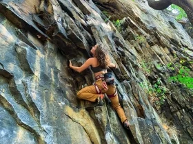 photo of woman rock climbing