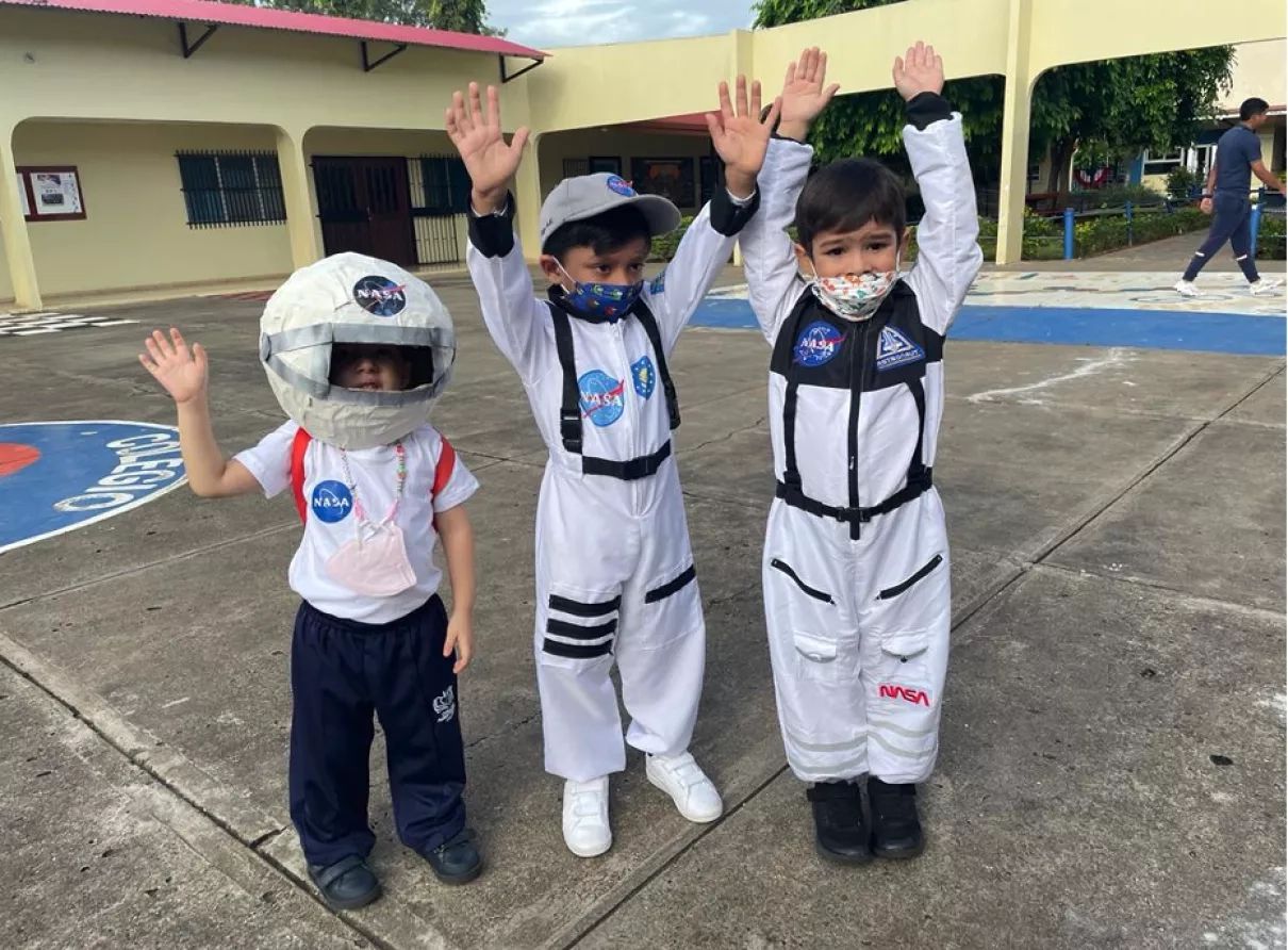 Three students dress as astronauts in anticipation of the amateur radio conversation with the International Space Station. Activities like this help generate awareness and excitement about science in the classroom. Credits: Disaster Fighters