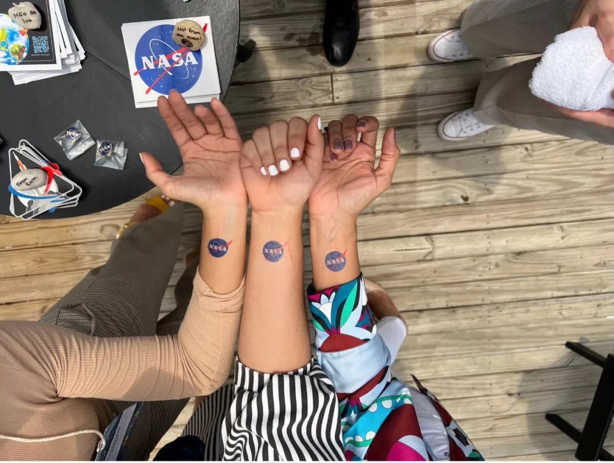 Fans of NASA show off their temporary tattoos. Credits: NASA