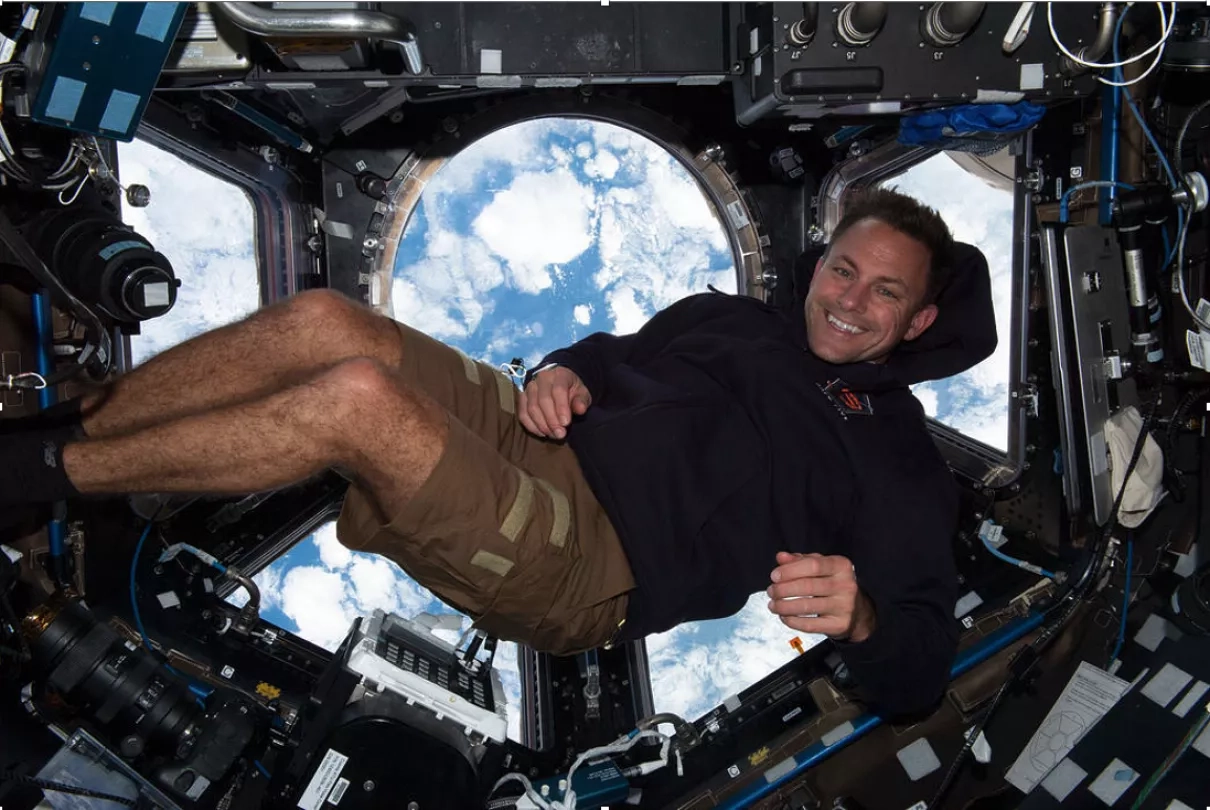 Josh Cassada, an astronaut living aboard the International Space Station, poses for a picture in the spacecraft's cupola, sometimes referred to as the station's "window to the world." From there, astronauts can monitor and photograph disasters on Earth. Credits: NASA/Nicole Mann