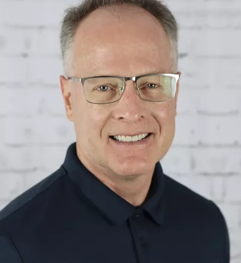 photo of man with glasses smiling