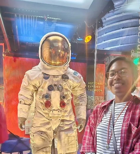 Elissa stands with Neil Armstrong’s space suit at the National Air and Space Museum in Washington, D.C. (Summer 2023)