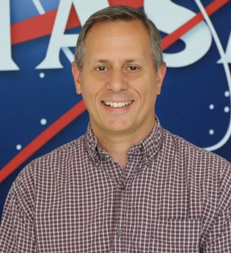 Kevin picutred in front of the original NASA logo