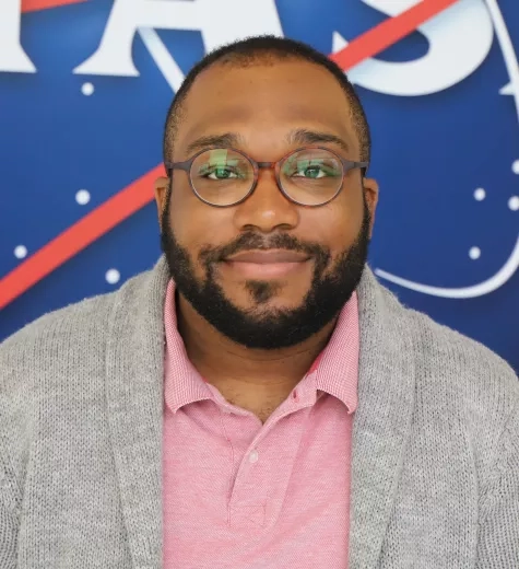 Selwyn pictured in front of the original NASA logo