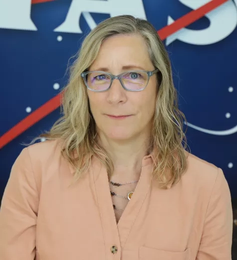 Sue pictured in front of the original NASA logo