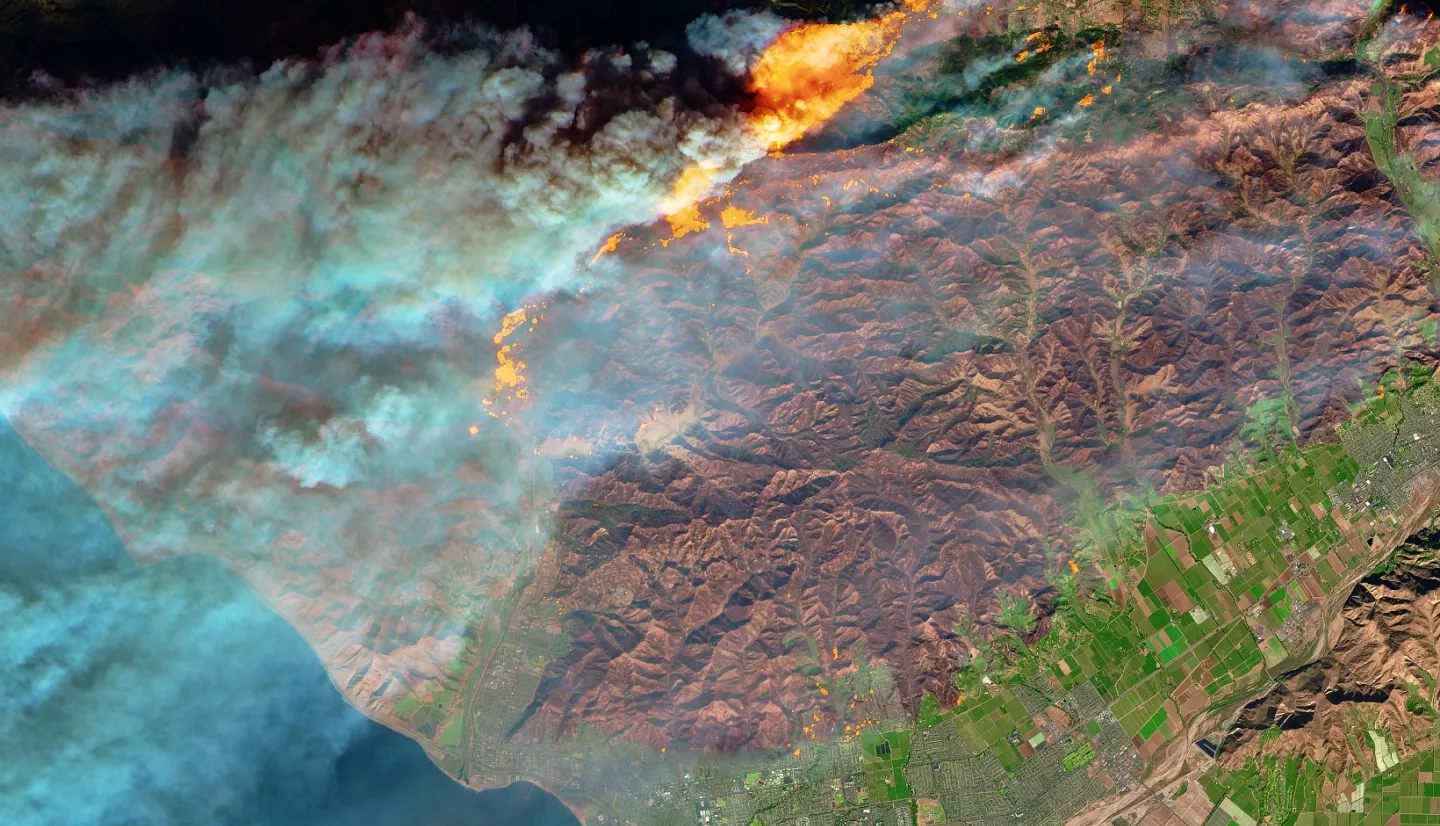 A view of an active fire and burn scar from space
