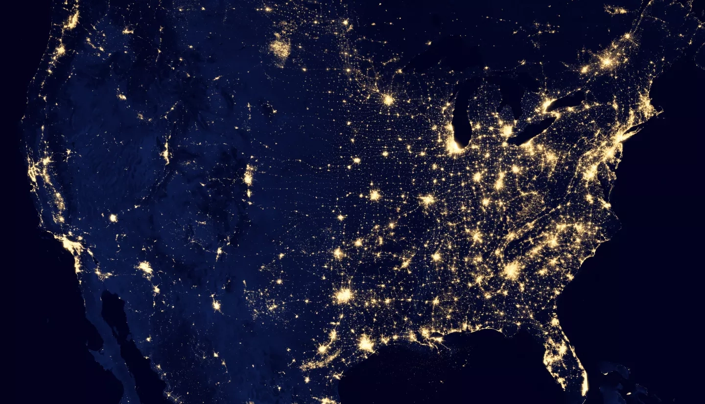 satellite image of the USA showing cities and other areas lit up by artificial light