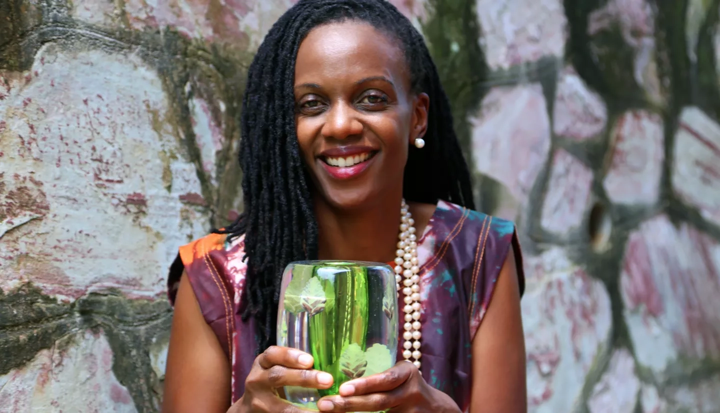 Photo of Catherine Nakalembe holding her award