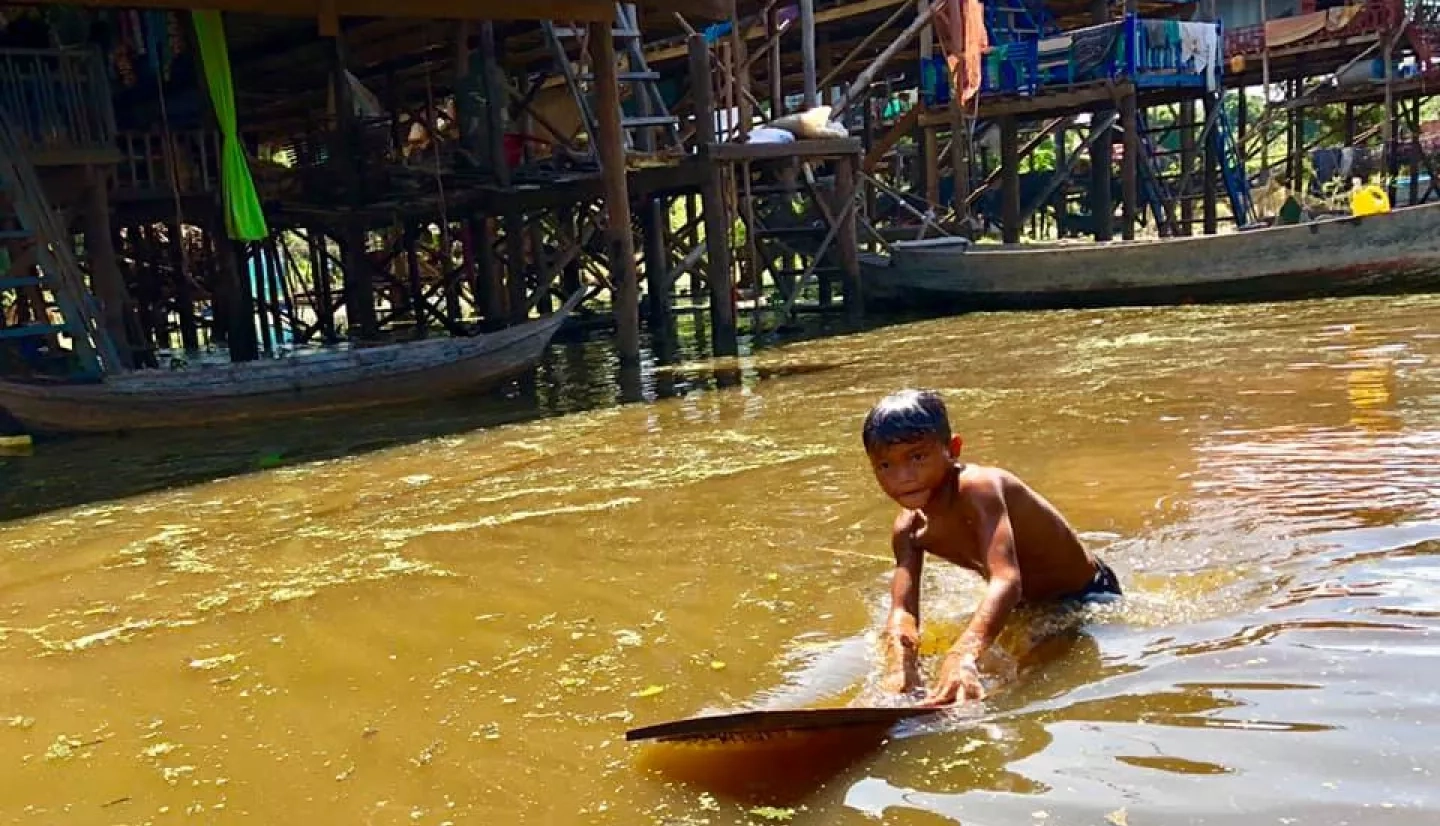photo of boy swimming in river in Cambodia