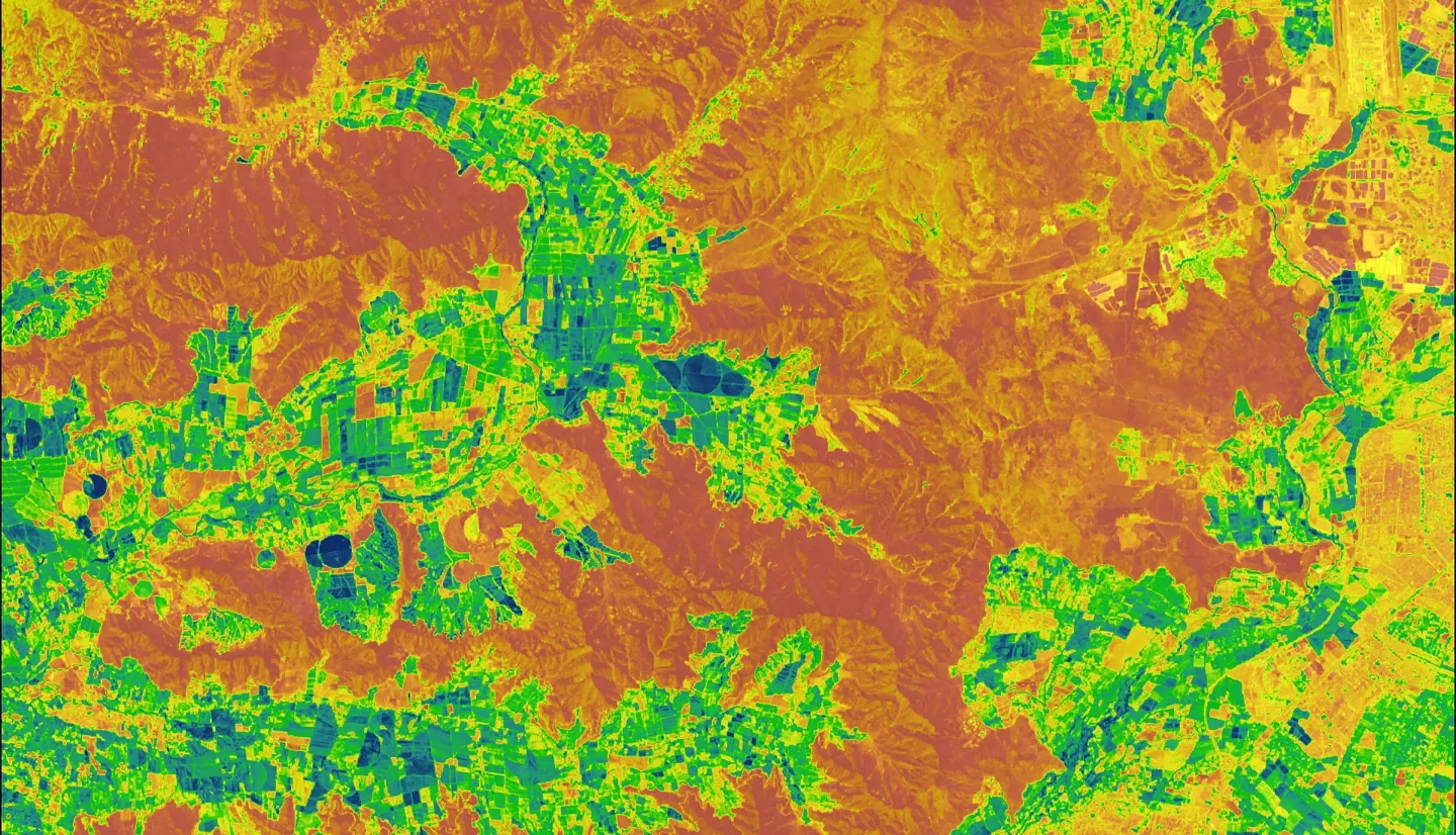 NDMI over a wildland-urban interface in central Chile generated from Landsat 8 OLI median-reduced data from March 1, 2018, through February 28, 2022. Orange areas represent vegetated shrublands and forests with low moisture content, and green areas represent vegetated agricultural areas with high moisture content. The NDMI was used as a proxy for wildfire fuel moisture in a wildfire risk assessment.