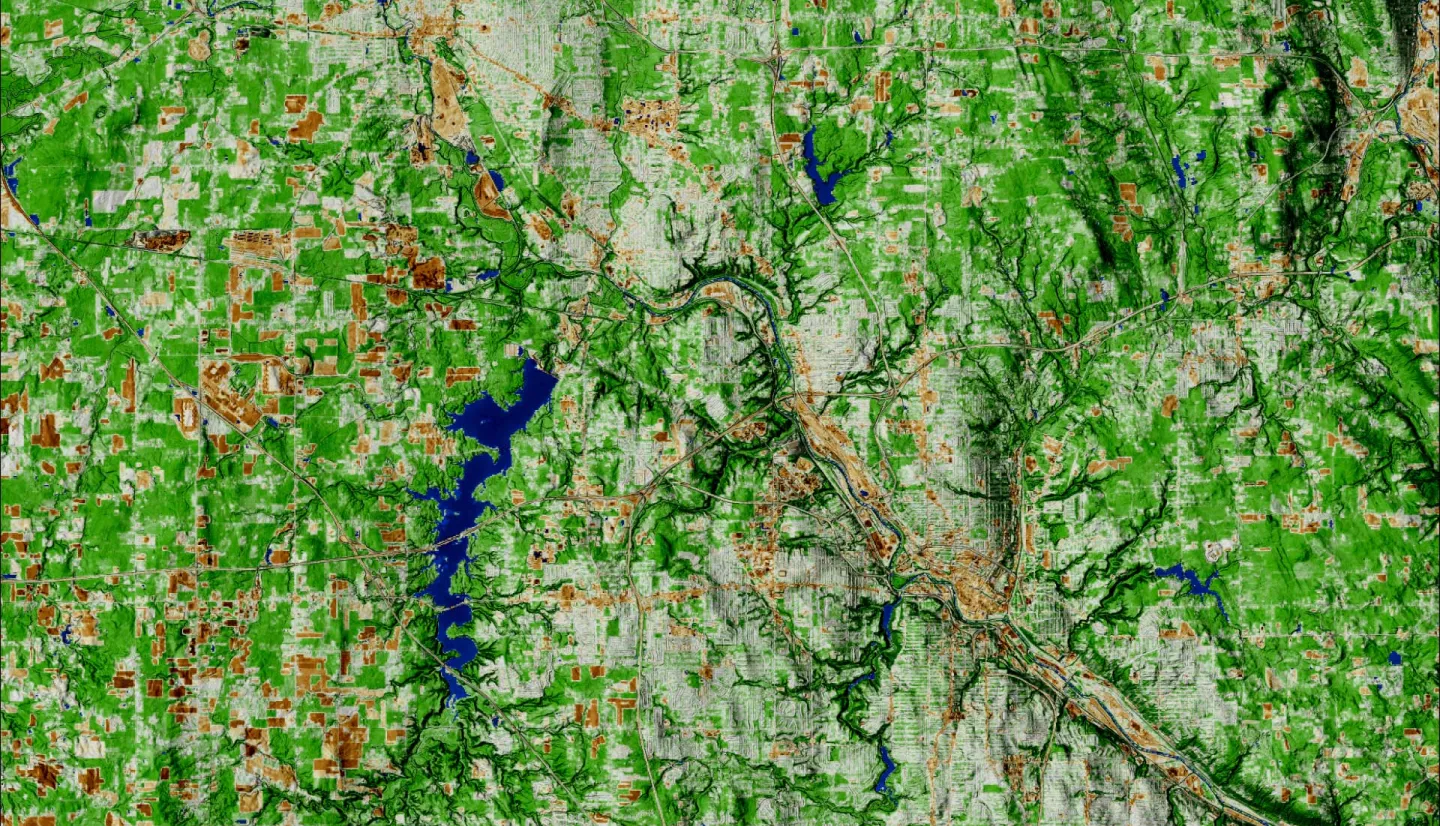 NDBI-processed imagery from a June 2022 Landsat 9 OLI-2 image. This composite image shows the cities of Warren (top left) and Youngstown (bottom right). The areas in white and brown represent the built environment. While areas in green represent land that is not as built-up, such as forest. Built-up areas can indicate where surface run off could occur, resulting in pluvial flooding.