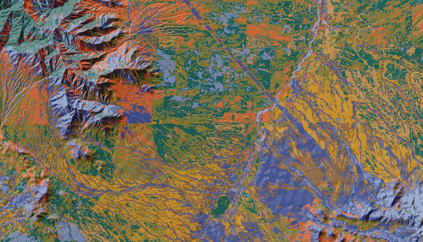 Land cover classification of the Arizona – Mexico border region from April 26, 2022 Landsat 8 OLI imagery. Colors represent land cover types determined by a machine learning clustering algorithm. Classifications help natural resource specialists assess vegetation cover and invasive spread, informing land management practices. The landscape impact of the border is visible as the horizontal break roughly mid-image––Coronado National Memorial and other conserved lands abut the border and experience landscape i