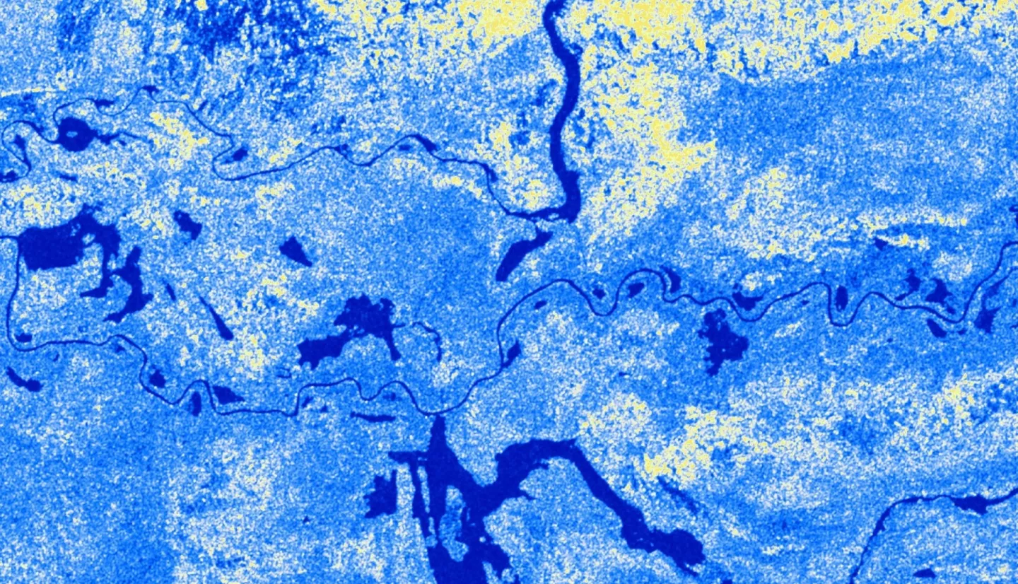 The satellite imagery is a Sentinel-1 Ground Range Detection C-SAR image from July 2nd, 2021, taken over the Sudd Wetland located in South Sudan. The image shows the 'VV' backscatter values, which correlate to vertical transmission and vertical reception from the C-SAR instrument and are used to classify wetland inundation extent. Low 'VV' values (blue) represent areas covered by open waters &amp; inundated land areas and high 'VV' values (yellow) represent dry land areas.