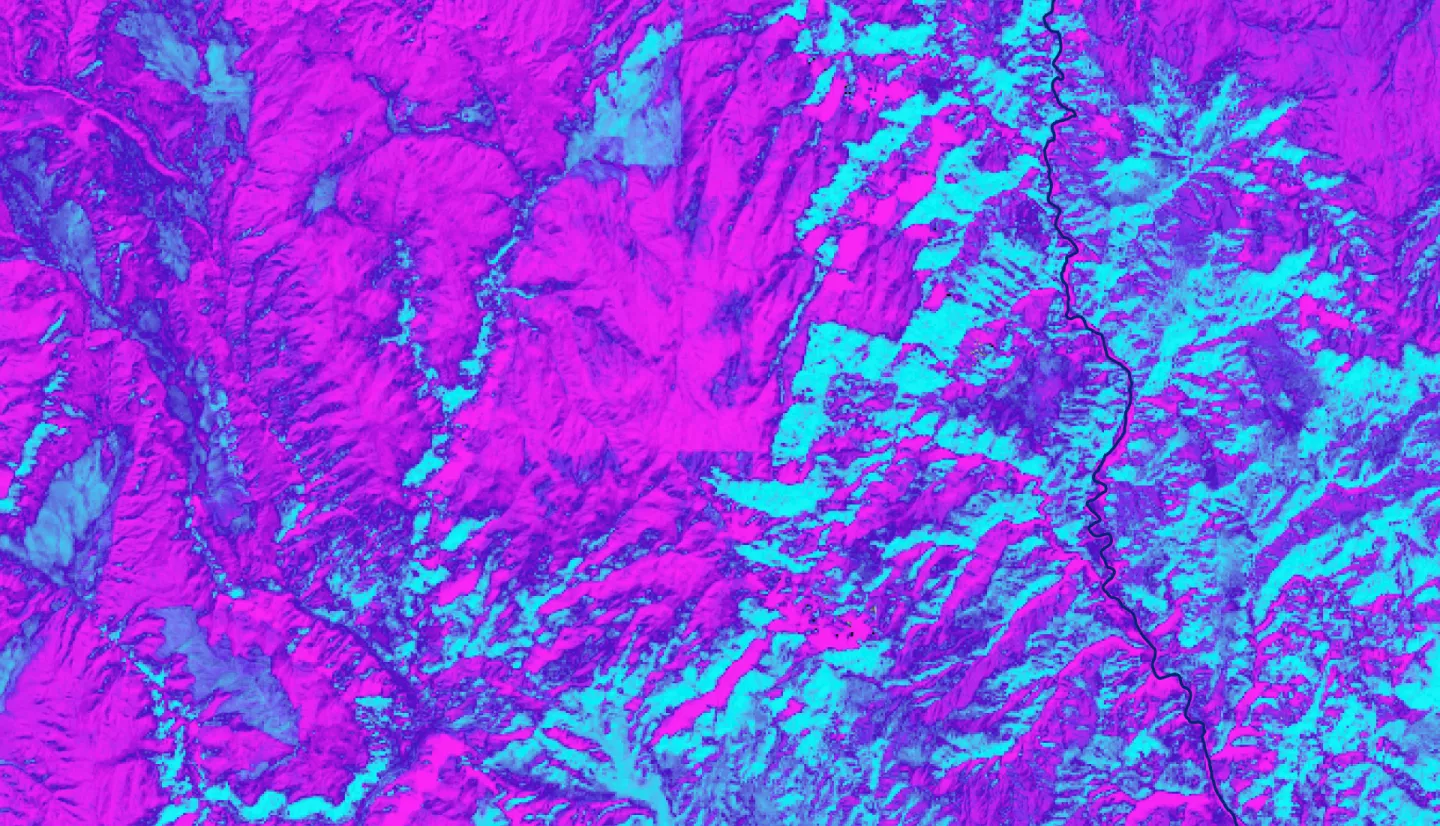 Tasseled Cap Wetness calculated from Landsat 9 OLI-2 imagery from October 25, 2022. The Paria River, shown in dark blue, passes through the landscape. Shades of lighter blue indicate higher values of Tasseled Cap Wetness, with the gradient going towards dark purple and then bright pink for the lowest values of Tasseled Cap. Areas with higher Tasseled Cap Wetness values indicate moister environments, which can enable invasive species proliferation in riparian ecosystems.