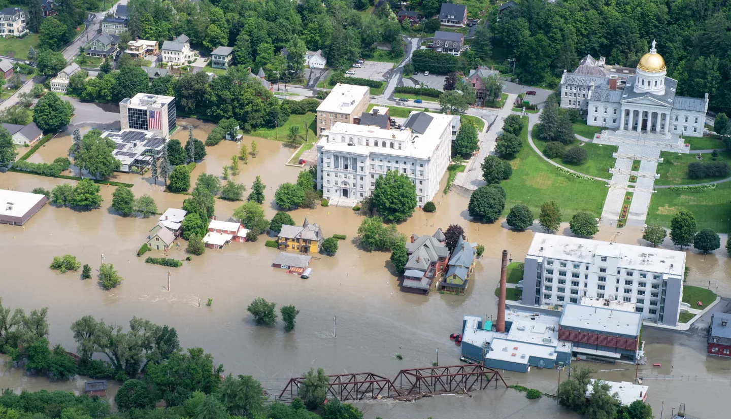 A Vermont National Guard helicopter surveys flood damage in the state's capital, Montpelier, Vt., July 11, 2023. Credits: U.S. Department of Defense, Air Force Senior Master Sgt. Michael Davis