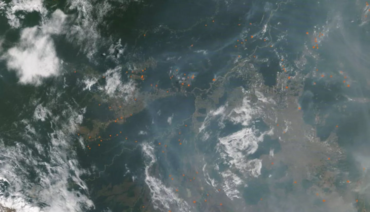 On September 3, the Moderate Resolution Imaging Spectroradiometer (MODIS) on NASA’s Terra satellite acquired this true-color image of smoke and fire near the border of Bolivia and Brazil. Numerous hot-spots, shown in red, mark areas where the thermal bands on the instrument detected high temperatures. When combined with typical smoke, as in this image, such hot spots mark actively burning fire. Credit: MODIS Land Rapid Response Team, NASA GSFC