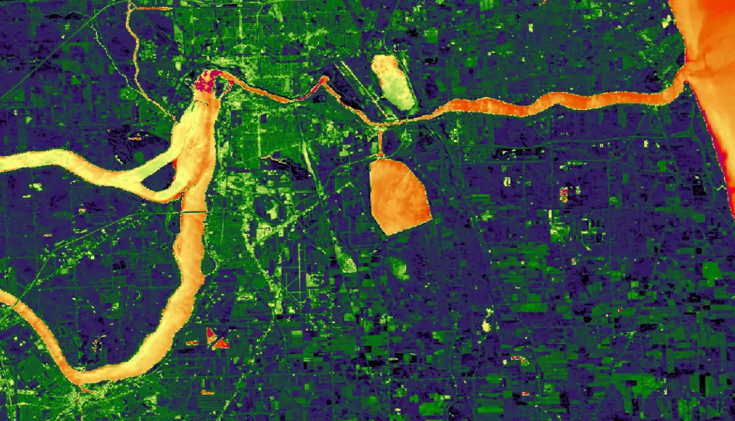 This is a processed image that shows the average of the Normalized Difference Water Index (NDWI) and the Modified NDWI (MNDWI) derived from June 1, 2017 Landsat 8 OLI data, with yellow and orange colors representing higher wetness relative to the dryer dark blue and green colors. The image shows the southern coast of Lake Ontario, centered on the city of Niagara Falls, New York, and indicates areas inundated by water.