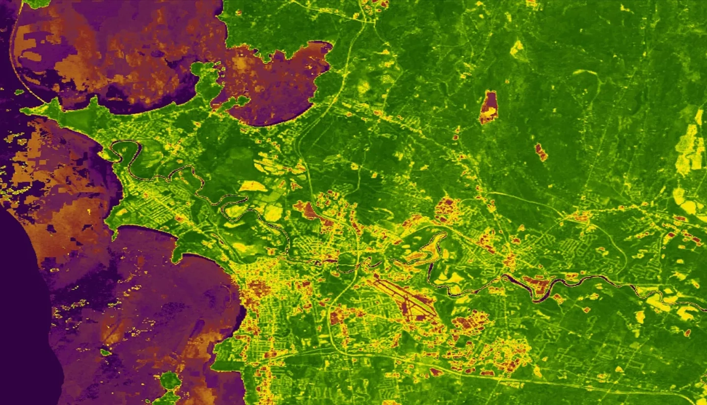 This image depicts a January through June 2019 Normalized Difference Vegetation Index (NDVI) map for the Burlington, Vermont, area derived from Landsat 8 Operational Land Imager (OLI) data. NDVI quantifies vegetation health by calculating the difference between two bands, near-infrared and red. The purple pixels in the image represent low NDVI values, indicating poor vegetation health, and the green pixels represent high NDVI values, indicating healthy vegetation.