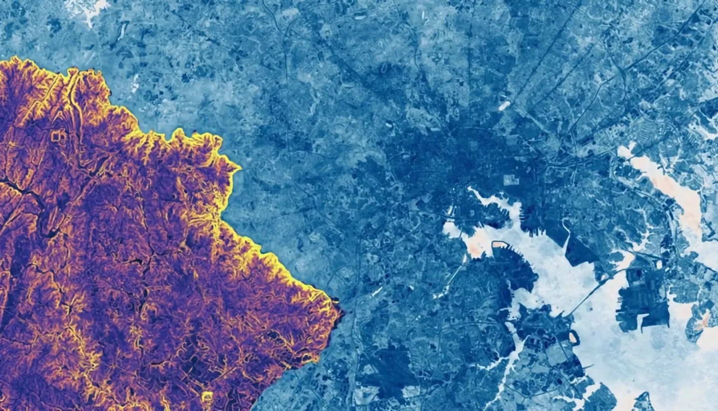 NDWI Composite from Landsat 8 tier 1 (2019) is shown with surface slope, derived from a statewide DEM of Maryland (2011), clipped to the border of Howard County, overlaid. The greater Baltimore area is shown; the merge of the Patapsco River and the Chesapeake Bay is seen lower right. Lighter shades of blue indicate higher surface and plant water content. In regards to the DEM, yellow shows a high degree of slope, while purple shows low slope. The convergence points of several watersheds along the Patapsco river (bright yellow border) can be identified, including the Tiber-Hudson watershed at Ellicott City. High NDWI values and steep slopes indicate areas in danger of flooding due to runoff.  Keywords: DEM, Landsat 8, NDWI, Ellicott City, watershed