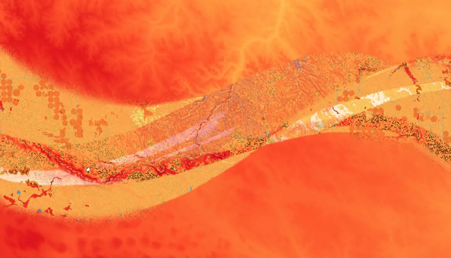 Blended image of a DEM from NASA’s SRTM, slope processed from the DEM, NLCD 2016 data, and a 2018 Soil Survey Geographic Database from the Natural Resources Conservation Service over the state of South Dakota, showing a section of the Rosebud Sioux Reservation Land. The dominant layer of DEM shows higher elevation in dark red and lower elevation in lighter red to yellow; all these layers help highlight the risk of flooding in this landscape.  Keywords: SRTM, DEM, NLCD, Soil Survey, South Dakota, Indigenous Peoples, Flood Mapping, Flood Risk